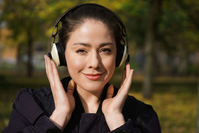 Portrait of young woman using smart phone outdoors