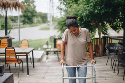 Rear view of woman sitting on table at cafe