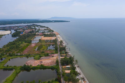 High angle view of sea and buildings against sky