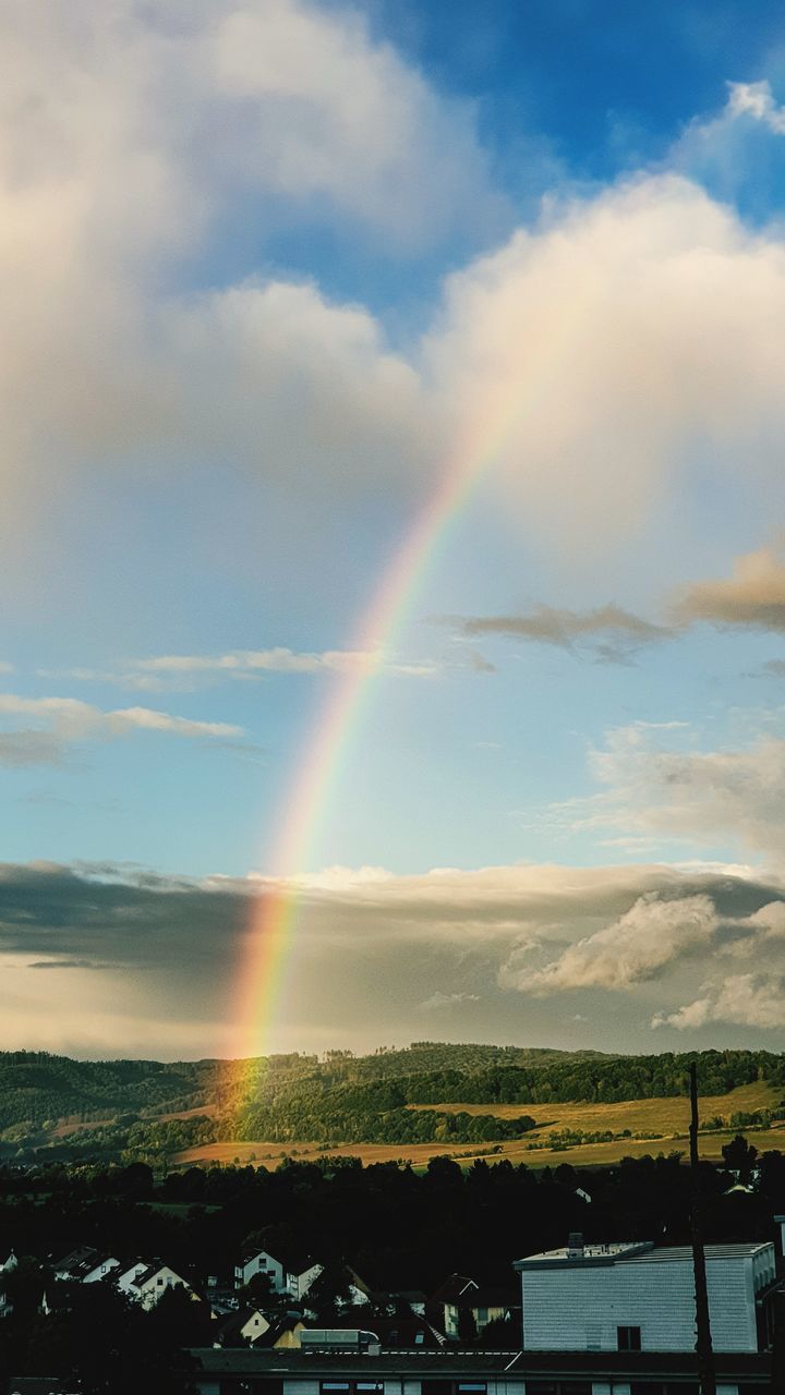 rainbow, cloud, sky, beauty in nature, nature, sunlight, scenics - nature, environment, multi colored, landscape, architecture, no people, horizon, tranquility, idyllic, tranquil scene, outdoors, day, mountain, built structure, dusk, building exterior, dramatic sky, building, water, non-urban scene, land, natural phenomenon, sunset