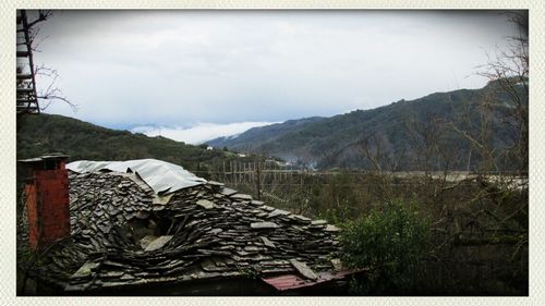 Mountain range against cloudy sky