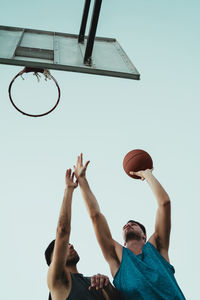 Young man playing with basketball