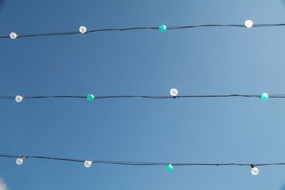 Directly above shot of light bulbs against blue sky