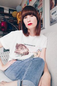 Portrait of young woman sitting at home