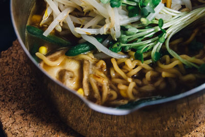 Close-up of fresh ramen noodles served in bowl on table
