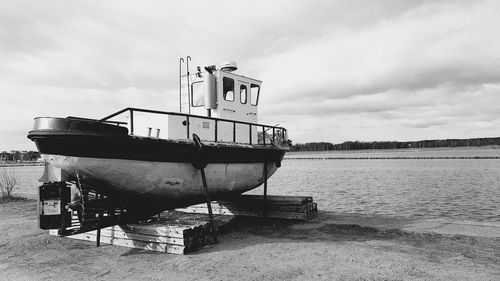 Ship moored in sea against sky