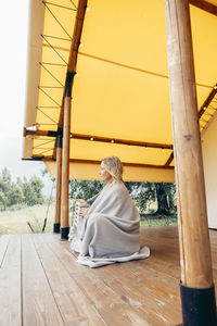 Rear view of woman sitting on steps
