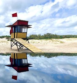 Lifeguard hut on beach against sky