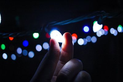 Close-up of hand holding illuminated lights