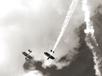 Low angle view of airshow against sky