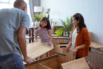 Happy family assembling furniture at home