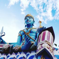 Low angle view of statue against cloudy sky