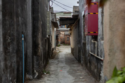 Empty alley amidst houses