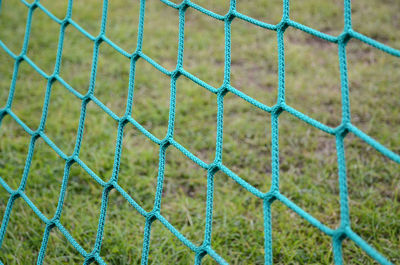 Full frame shot of soccer net against grass