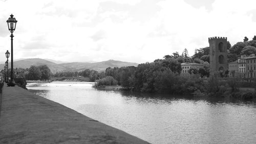 River by buildings against sky