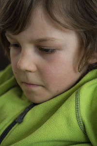 Close-up of boy relaxing on bed at home