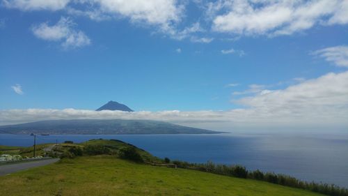 Scenic view of sea and pico island against sky