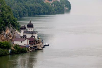 Building by river against mountain