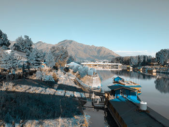 High angle view of boats moored in water against clear sky