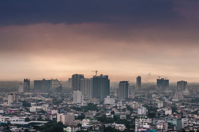 High angle view of buildings in city against sky during sunset