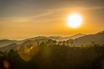 Scenic view of silhouette mountains against sky during sunset