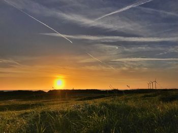 Scenic view of field against sky during sunset