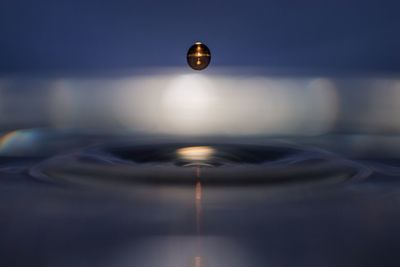 Close-up of illuminated light against water