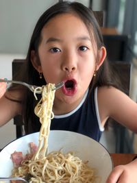 Portrait of girl eating spaghetti