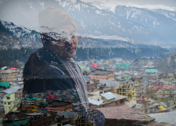 Double exposure of woman and townscape during winter