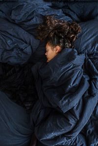 High angle view of girl sleeping in bed