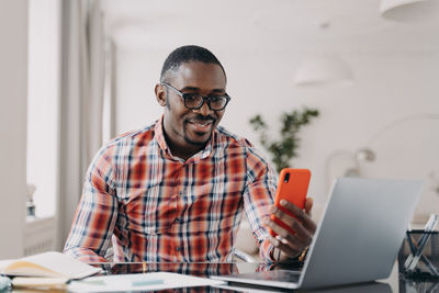 Young man using laptop at office