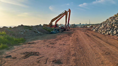 Construction site by road against sky