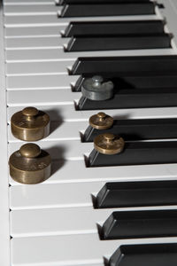 Close-up of weights on piano keys