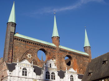 Low angle view of historic building against blue sky