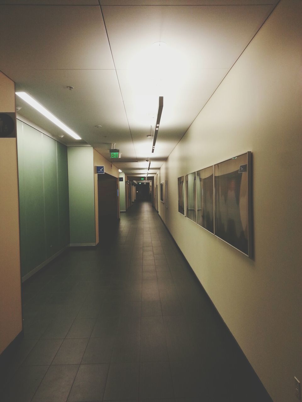 indoors, illuminated, ceiling, lighting equipment, corridor, the way forward, empty, flooring, architecture, built structure, tiled floor, absence, tile, interior, wall - building feature, subway, diminishing perspective, wall, electric light, modern