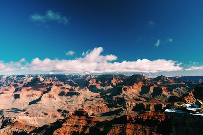 Scenic view of mountains against cloudy sky