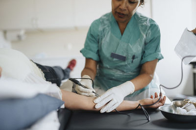 Female surgeon operating patient in hospital