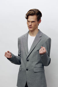 Portrait of businessman standing against white background