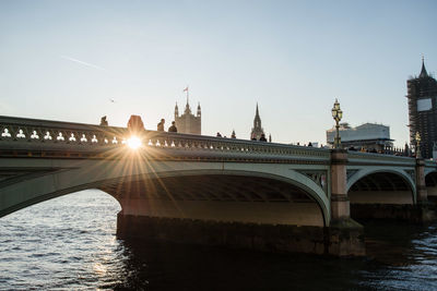 Bridge over river during sunset