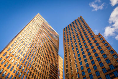 Low angle view of modern buildings against clear blue sky