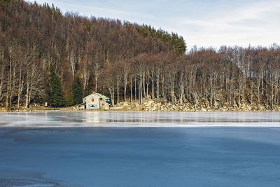 Mountain refuge and winter frozen lake in italian mountains, parma
