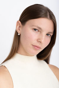 Close-up of young woman against white background