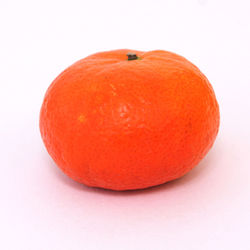 Close-up of orange apple against white background