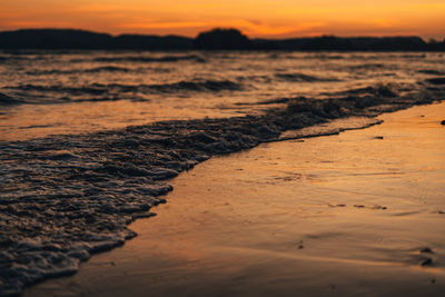 Scenic view of beach against sky during sunset