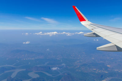 Aerial view of aircraft wing against sky