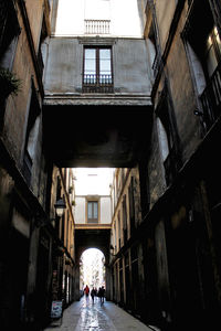 People walking on street amidst buildings in city