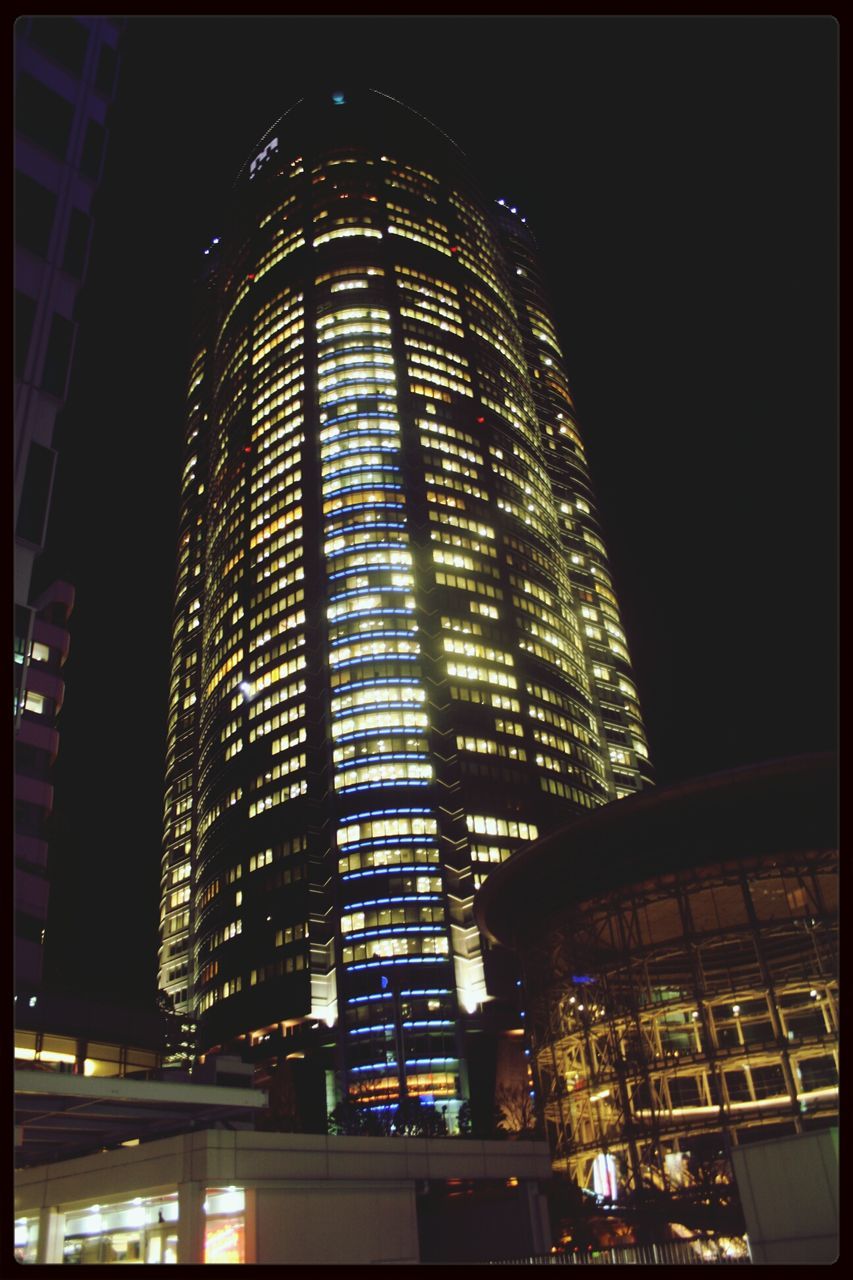 illuminated, architecture, night, built structure, building exterior, low angle view, city, modern, building, office building, transfer print, skyscraper, sky, lighting equipment, auto post production filter, tower, city life, tall - high, no people, outdoors