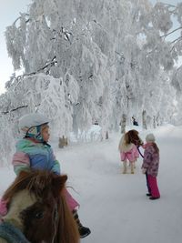 People on snow covered field