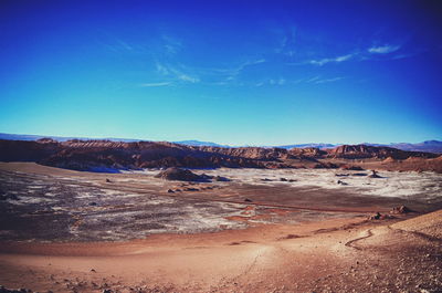 View of desert against blue sky