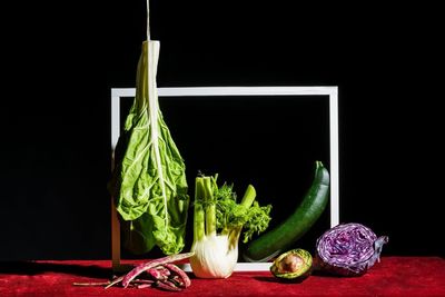 Close-up of vegetables on table against black background